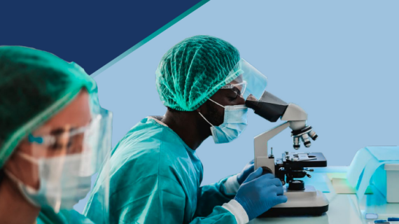 Person looking through microscope